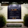 A dark double door with a Brandson LED solar lamp illuminating the area in front of it. Produktbild-Vorschau