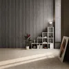 A modern living room with acoustic wall panels, a plant, and a bookshelf. Náhled obrázku produktu