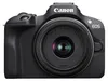 A front view of a black Canon EOS R100 camera with a lens attached, set against a white background. Voir les images du produit