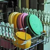 Colorful plates stacked in a dishwasher rack. Náhľad obrázku produktu