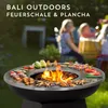 People are gathered around a fire pit with food cooking on it in a backyard setting. Produktbild-Vorschau