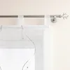 A close-up view of a white sheer curtain with a decorative branch pattern and a metal curtain rod. Produktbild-Vorschau