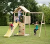Children playing on a wooden playground set in a grassy yard. Podgląd zdjęcia produktu