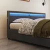 A close-up view of a modern bed with blue LED lighting in the headboard and a green blanket draped over it. Voir les images du produit