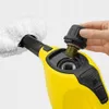 A hand is shown holding a black cap with a brass screw fitting, about to insert it into a yellow steam cleaner handle. Náhled obrázku produktu