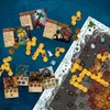 A collection of board game components, including cards, tokens, and board pieces, laid out on a blue surface. Produktbild-Vorschau