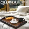 A breakfast tray with croissants and coffee on a bed. Anteprima dell’immagine prodotto
