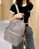 A person is holding a backpack. Podgląd zdjęcia produktu