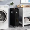 A slim black storage cart is placed next to a washing machine and a bathroom vanity. Produktbild-Vorschau