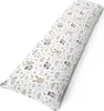 A long, cylindrical pillow with a white background and a pattern of cartoon animals and leaves. Produktbild-Vorschau