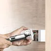 A person is using a cordless screwdriver to install an electrical outlet. Voir les images du produit