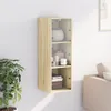 A wooden wall cabinet with glass doors mounted on a white wall, next to a potted plant and a sofa. Anteprima dell’immagine prodotto