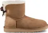 A single brown Ugg boot with a bow on the back, shown against a white background. Produktbild-Vorschau