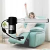 A woman is sitting in a recliner chair and listening to music, with an electric lift motor in the foreground. Produktbild-Vorschau
