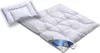 A white down comforter and a small white pillow are laid out on a white surface. Produktbild-Vorschau