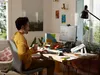 A man is working at a desk in a home office setting. Anteprima dell’immagine prodotto
