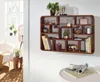 A wooden wall shelf filled with decorative items and books, placed in a living room setting. Voir les images du produit