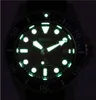 A close-up shot of a luminous watch face in the dark. Podgląd zdjęcia produktu