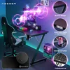 A gaming setup featuring a KESSER gaming desk and chair, with a computer and monitor. The image is enhanced with vibrant LED lighting and promotional graphics. Produktbild-Vorschau