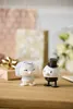 Two wedding-themed bobblehead figures on a wooden surface, with gift boxes and flowers in the background. Produktbild-Vorschau