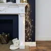 Christmas decorations on a fireplace with fairy lights. Produktbild-Vorschau
