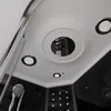 A close-up view of the ceiling and upper walls of a modern shower cabin, highlighting the showerhead, lights, and a central rain shower feature. Anteprima dell’immagine prodotto