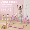 A young girl is using a purple gymnastics bar in a child's room. There are also decorative chairs and toys in the background. Voir les images du produit