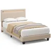 A beige upholstered bed with a wooden headboard detail, two white pillows, and a beige and gray throw blanket. Náhled obrázku produktu