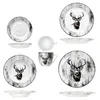 A collection of porcelain tableware with a deer motif, arranged against a white background. Voir les images du produit