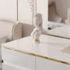 A close-up of a white, high-gloss dresser with a decorative bust on top. Produktbild-Vorschau