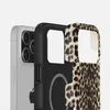 A close-up view of an iPhone case with a leopard print pattern, partially covering a silver iPhone. Produktbild-Vorschau