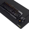 A gaming keyboard, mouse, and XXL mousepad are displayed on a black surface. Produktbild-Vorschau