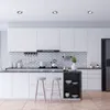 A modern kitchen with white cabinets, a tiled backsplash, and a black countertop. Produktbild-Vorschau