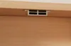 A close-up view of a vent or air outlet on a wooden surface, likely part of a desk or cabinet. Náhled obrázku produktu