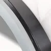 A close-up view of a layered, curved object, likely a mirror frame, showing different textures and colors. Náhľad obrázku produktu
