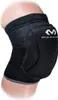 A close-up of a black knee brace on a person's leg. Produktbild-Vorschau