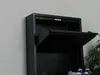 A black metal shoe cabinet with one of its doors open, revealing the interior. A pair of shoes is visible at the bottom. Voir les images du produit