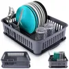 A dish drying rack filled with plates, glasses, and cutlery. Produktbild-Vorschau
