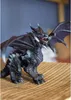 A detailed figurine of a dragon with wings spread, standing on a woven surface. Voir les images du produit