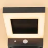 A close-up of a black outdoor solar light with a white illuminated frame. Produktbild-Vorschau