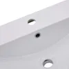 A close-up view of a white ceramic sink with two drain holes. Produktbild-Vorschau