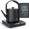 A black electric kettle with a gold handle and lid sits on its charging base, with a marketing graphic on the right. Produktbild-Vorschau