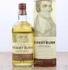 A bottle of Robert Burns Single Malt Scotch Whisky and its cylindrical packaging are displayed against a white background. Produktbild-Vorschau