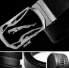 A collage of images showing a black leather belt with a silver buckle featuring a jaguar logo, and close-ups of the belt's texture. Anteprima dell’immagine prodotto