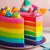 A slice of a rainbow cake is shown, with colorful layers and frosting. Small, decorative swirls of frosting with sprinkles are on top of the cake. Náhled obrázku produktu