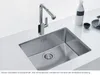 A stainless steel kitchen sink with a modern faucet, set on a white countertop. Náhled obrázku produktu