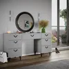 A modern vanity table with a round mirror and decorative elements, set in a room with a balcony view. Podgląd zdjęcia produktu