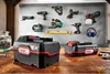 A collection of power tools and batteries displayed on a workbench and wall. Produktbild-Vorschau
