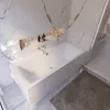 A modern bathroom with a white bathtub and marble walls. Produktbild-Vorschau