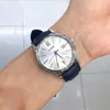 A person's wrist wearing a silver Casio watch with a blue leather strap. Voir les images du produit